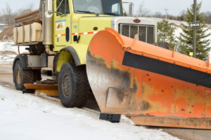 Curb saver block installed on plow